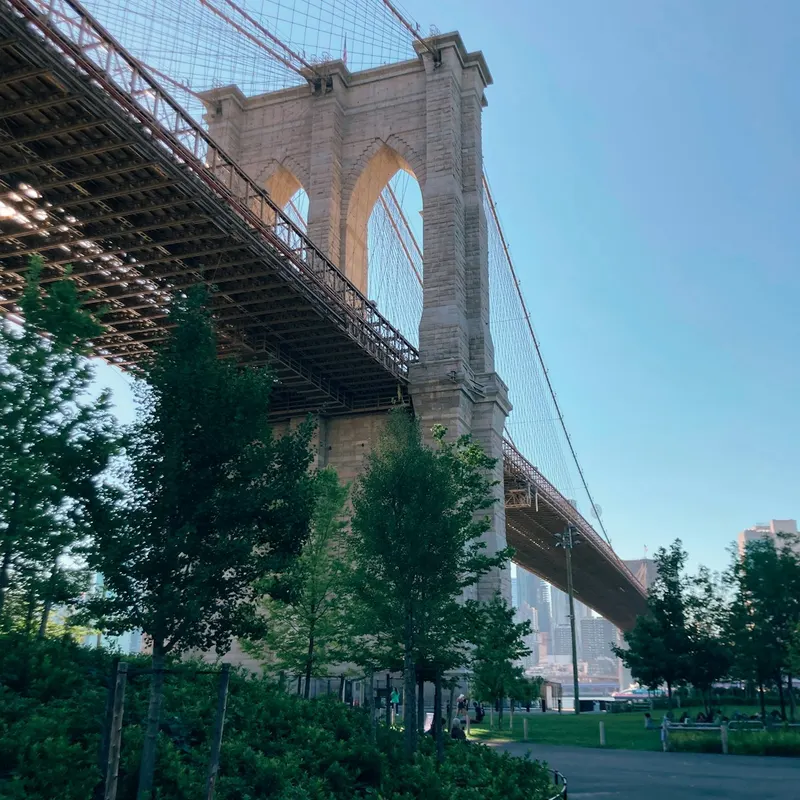 Brooklyn Bridge seen from a riverside park
